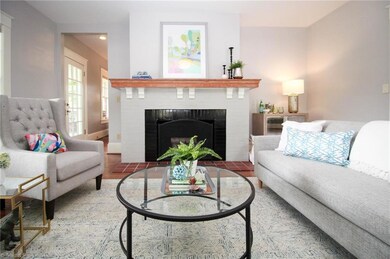 Living room with wood burning fireplace.