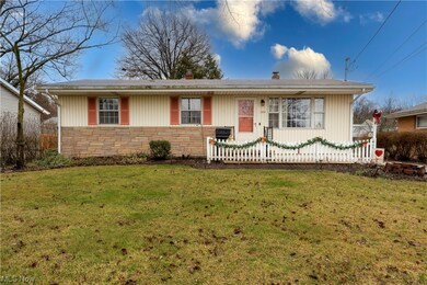 Single story home featuring a front lawn
