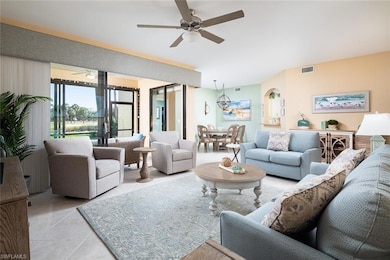 Living room featuring visible vents, ceiling fan, 