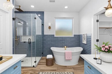 Bathroom featuring vanity, a stall shower, a free