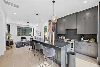 Kitchen featuring gray cabinetry, an island with 