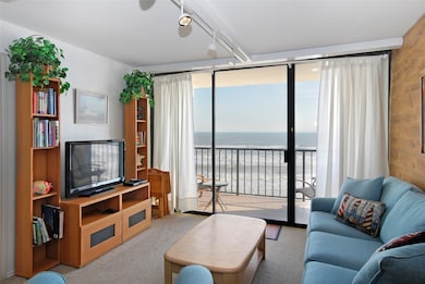 The living room features one of two private balcon