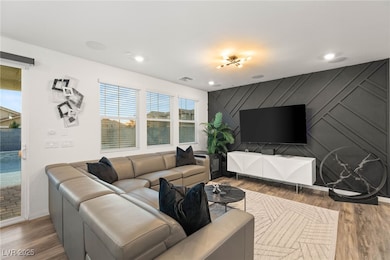 Living area featuring wood finished floors, an acc