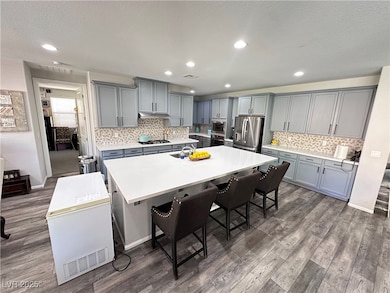 Kitchen with stainless steel refrigerator with ice