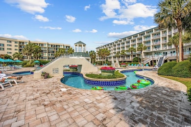 Community pool with a patio