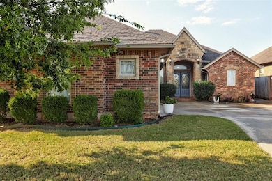 View of front of house featuring brick siding, a front lawn, and roof with shingles