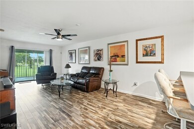 Living room with wood finished floors and a ceiling fan