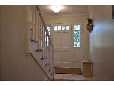 The front entry door has large side lights which a