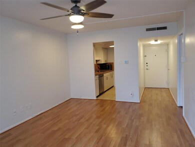 Empty room featuring a ceiling fan, light wood-st