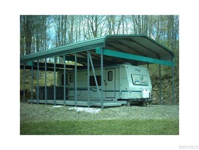 Exterior Front. Prowler camper with carport and 