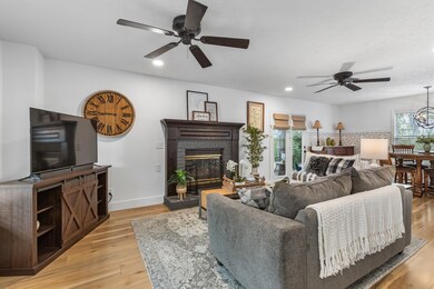 This large living room is filled with natural light and seamlessly connects to the porch, dining room, and kitchen, ensuring you stay connected to everything happening around you.
