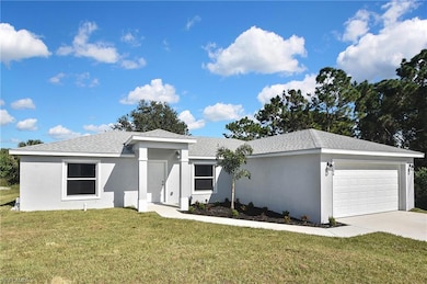 Ranch-style house with stucco siding, a front yard, a garage, and roof with shingles