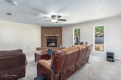 Living room with ornamental molding, a textured ce