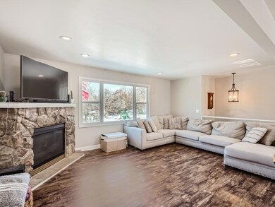 Living Room with a corner gas fireplace with a brick surround.   Big picture window with views of the neighborhood park.  New brick paver patio in the fenced backyard.