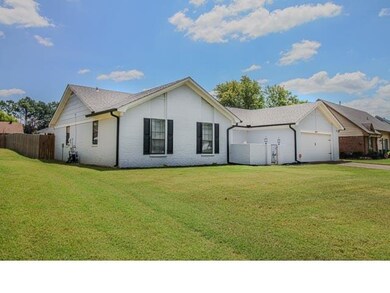 Single story home with a front yard and a garage