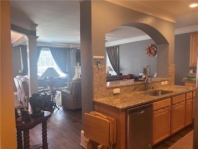 Kitchen featuring a sink, a peninsula, open floor 