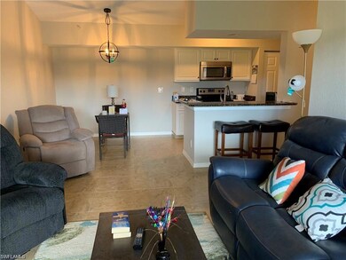 Living room with light tile patterned flooring and