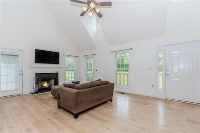 Living area featuring high vaulted ceiling, a high