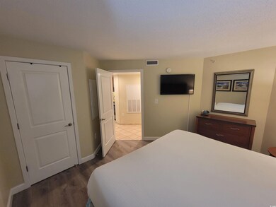 Bedroom featuring wood finished floors and baseboards