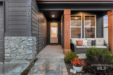 Entrance to property with stone siding and covered porch
