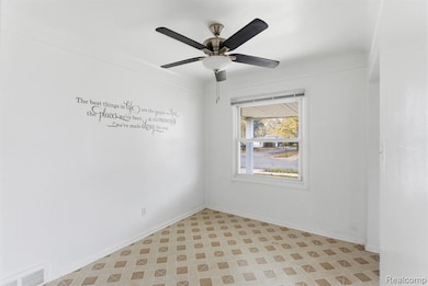 Empty room featuring light floors and baseboards