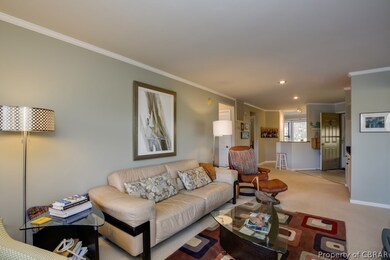 A view to the entry way and kitchen from the livin
