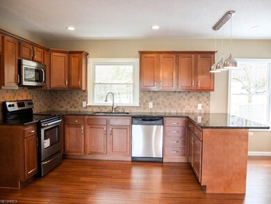 Kitchen has stainless steel appliances and tile ba