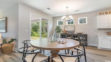 Dining space featuring light wood-style floors, a 
