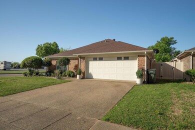 Ranch-style house with brick siding, driveway, a f