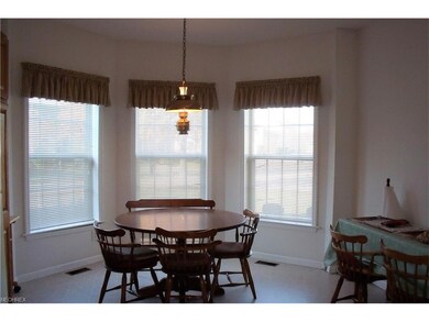 Bright open eat in area with bayed window.