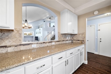 Kitchen with white cabinets, dark wood-style floor