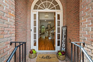 Front door with side windows and half circle window above door and metal handrails for safely walking up the steps