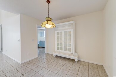Unfurnished room with baseboards and light tile pa