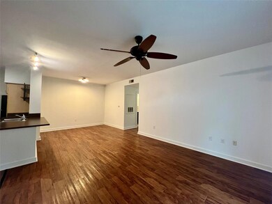 Unfurnished living room featuring ceiling fan and