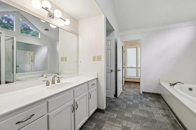 The Main-Level Primary Suite features Double Vanit