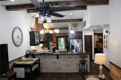Kitchen with a breakfast bar area, beam ceiling, c