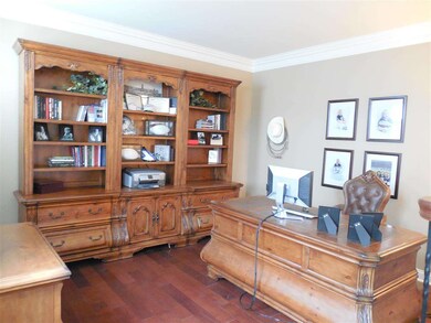 The office/den with crown molding and the...