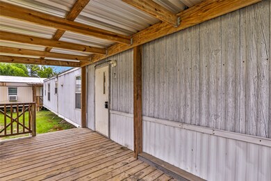 This photo shows a covered porch area of a mobile