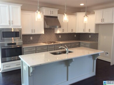 The masterful gourmet kitchen features granite cou