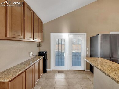 Kitchen featuring lofted ceiling, light tile patte