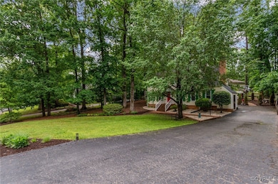 View of front facade with a front lawn, asphalt dr