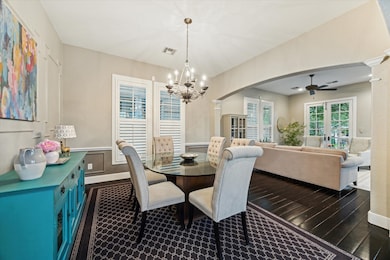 The spacious dining room is anchored by a chandeli