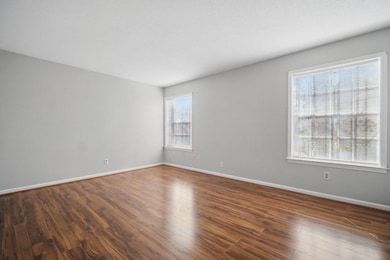 Unfurnished room featuring baseboards and wood finished floors