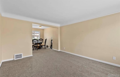 Empty room with carpet flooring and ornamental molding