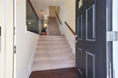 Stairs with hardwood / wood-style floors and ornam