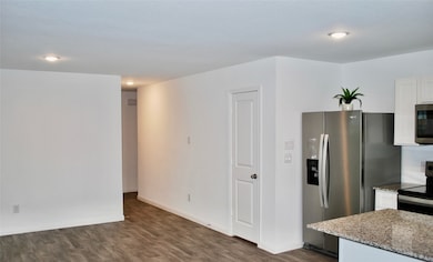 The kitchen is open to the breakfast and living room with laminate flooring.