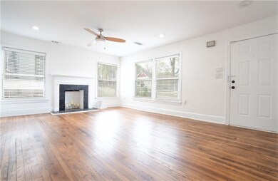 Unfurnished living room with baseboards, a tiled f
