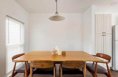 Dining room featuring dark wood-style flooring