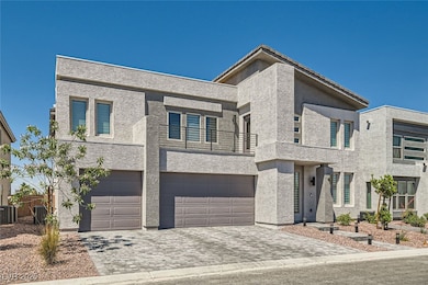 Modern home with a balcony, a garage, decorative driveway, and stucco siding