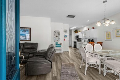 Dining area with light wood-style floors, a chandelier, and recessed lighting